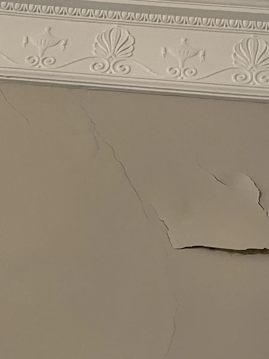 Delaminating plaster in a period home, documented before repair and repainting.