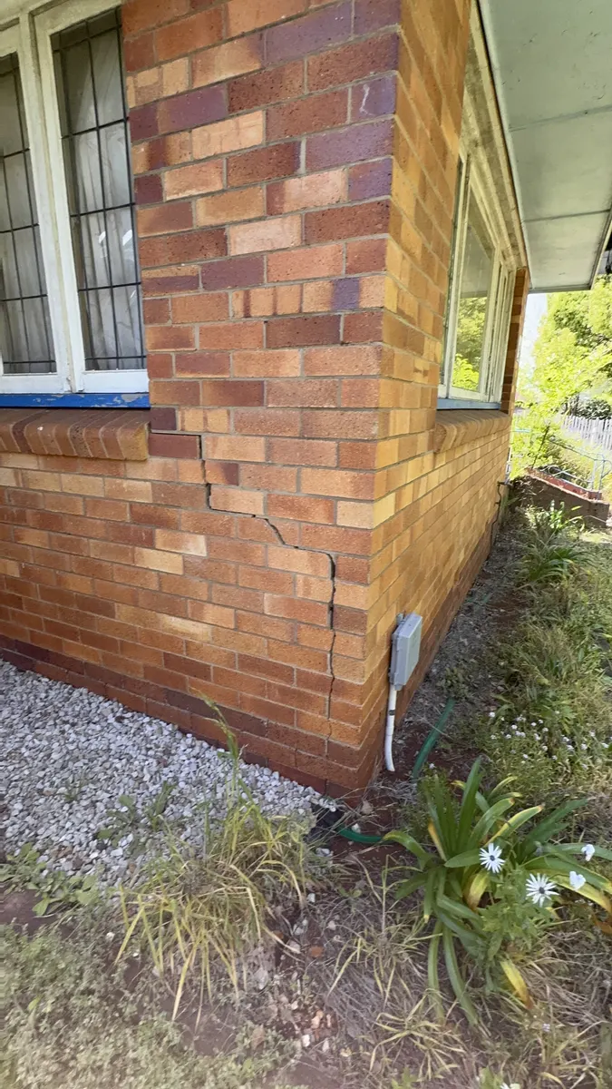 Stepped cracking in external brickwork, a classic sign of foundation movement that underpinning or grout injection can stabilise.